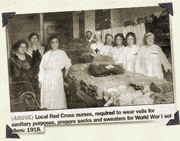 Local Red Cross nurses, required to wear veils for sanitary purposes, prepare socks and sweaters for WWI Soldiers: 1918.